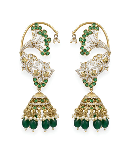 Gold plated emerald green ear cuff jhumka earrings with American diamond stones, green beads and pearl hangings on a white background