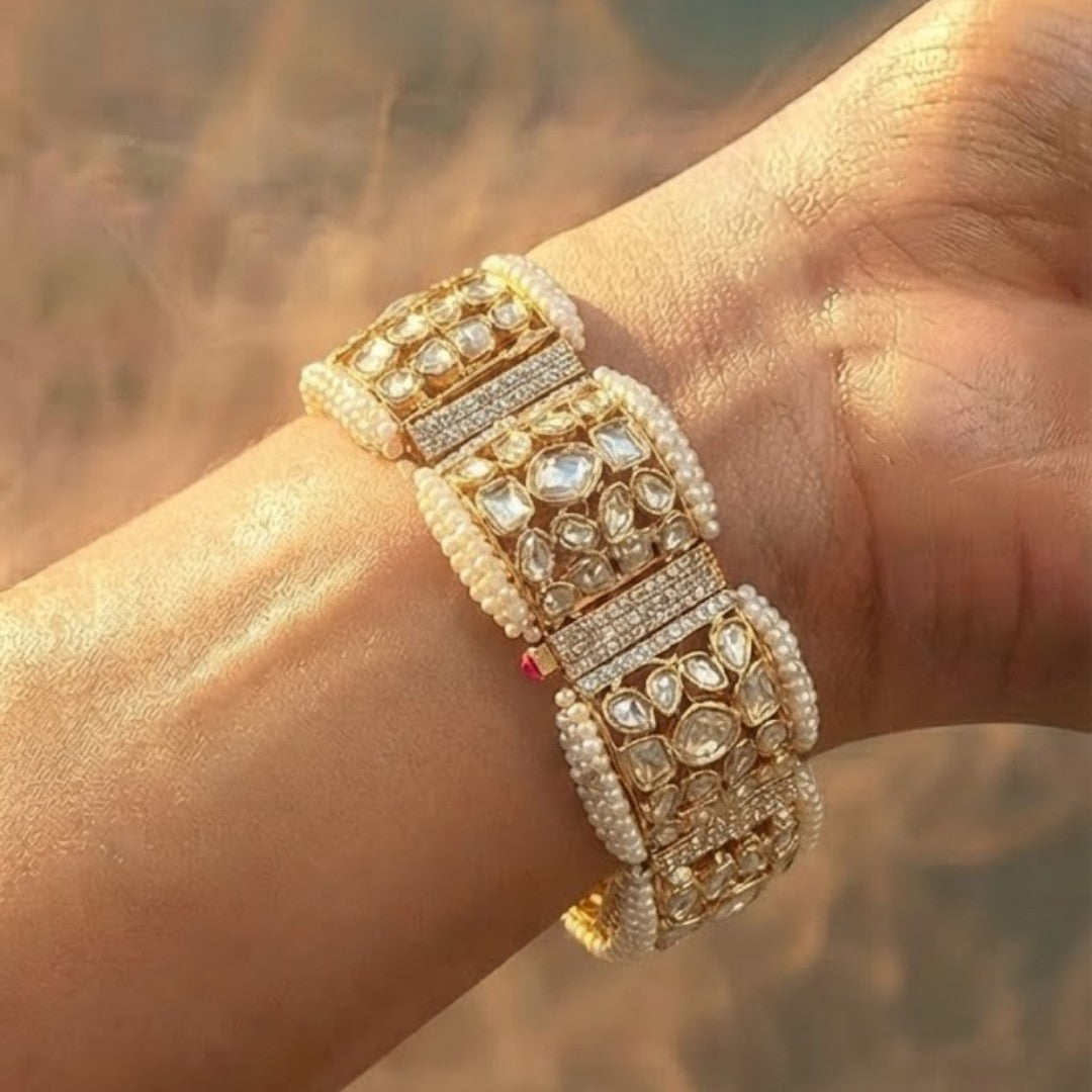 "Gold-tone bridal bracelet with pearl beading and white kundan polki crystal panels"
