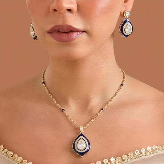 Gold finish pendant necklace with navy blue enamel border and pear-cut zircon centre stone