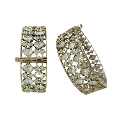 Elegant Kundan - Style Gold Plated Bangles with White Polki Stones - Auraa Trends - Bangles -  - Auraa Trends - Close - up of elegant gold - plated kundan - style bangles with white Polki stones, displayed on a dark green fabric roll – traditional Indian ethnic jewelry