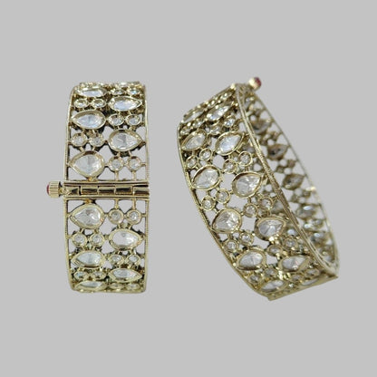 Elegant Kundan - Style Gold Plated Bangles with White Polki Stones - Auraa Trends - Bangles -  - Auraa Trends - Close - up of elegant gold - plated kundan - style bangles with white Polki stones, displayed on a dark green fabric roll – traditional Indian ethnic jewelry