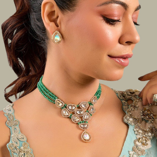 Emerald Beaded Kundan Necklace with Teardrop Pendant - Auraa Trends - choker - # - Auraa Trends - beaded necklace with delicate Kundan work and teardrop pendant, accessorized with matching teardrop stud earrings and pale blue embroidered garment.