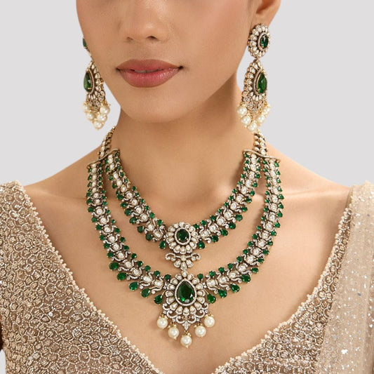 Emerald Royale Layered Necklace Set with Earrings - Auraa Trends - Necklace -  - Auraa Trends - Woman draped in a layered necklace adorned with emerald green and white stones, topped with pearl drops, complemented