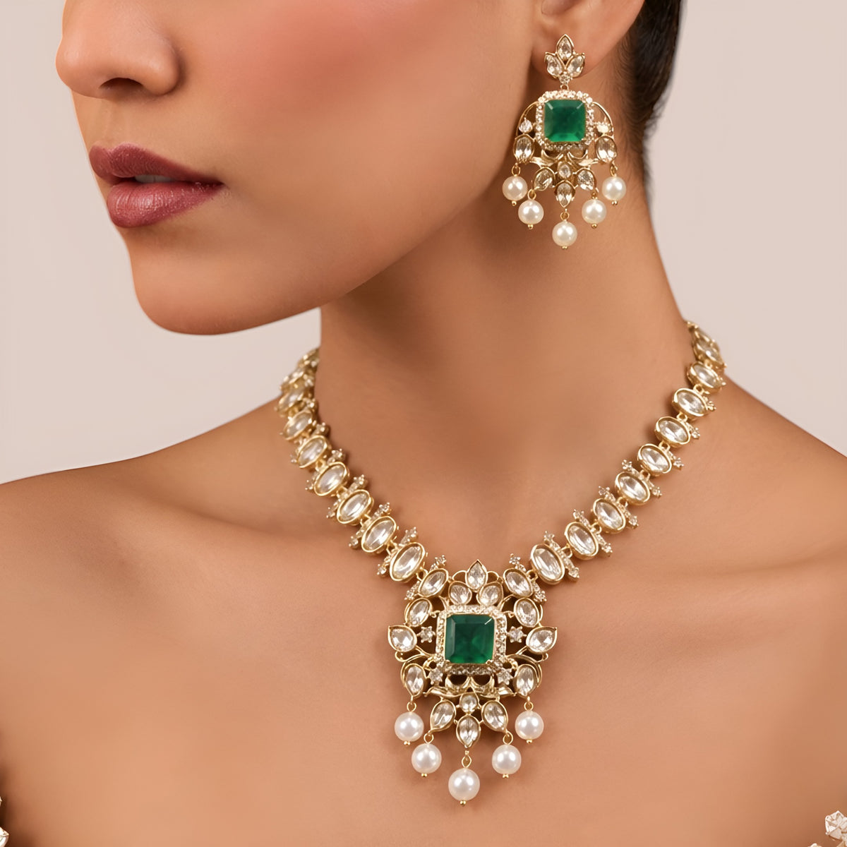Gold finish kundan polki necklace set with emerald green square stone pendant and pearl drops