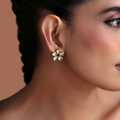 Pair of gold-finish kundan floral stud earrings with four clear polki style petals and a small emerald green centre stone