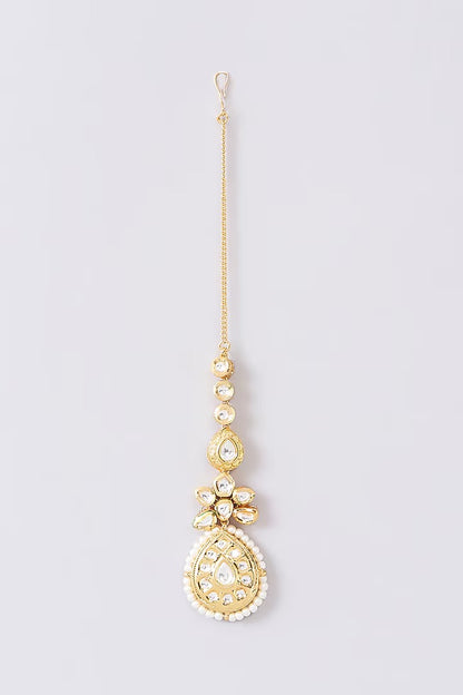 Gold-toned bridal kundan necklace set with pearl edging, maang tikka, and matching jhumka earrings