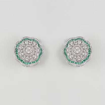 "Silver rhodium-plated floral stud earrings with white American diamonds and emerald green baguette stone halo"