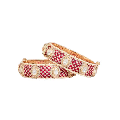 "Set of two gold-toned bangles with ruby-red kundan stone work, white polki stone accents and pearl border, traditional Indian bridal jewelry"