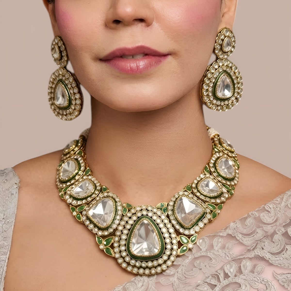 Antique gold polki kundan collar necklace set with large clear stones, green enamel borders, emerald leaf accents and matching pear drop earrings