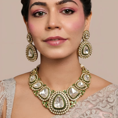 Antique gold polki kundan collar necklace set with large clear stones, green enamel borders, emerald leaf accents and matching pear drop earrings