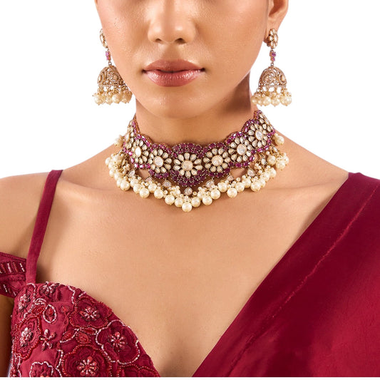 Gold Finish Kundan Polki & Deep Ruby Stone Choker Necklace Set - Auraa Trends - Necklace -  - Auraa Trends - Gold finish choker necklace with kundan polki, ruby stones, pearls, and floral motifs Traditional Indian bridal choker set with jhumka earrings Ruby red kundan polki necklace with matching jhumka earrings Floral motif choker necklace in gold with pearls and ruby accents