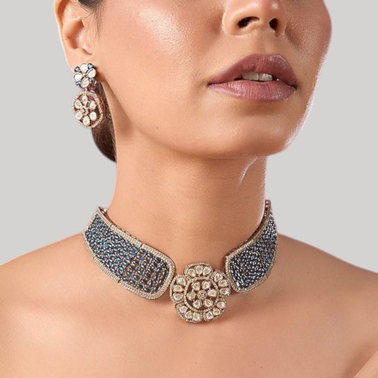 Gold - Plated Blue Stone Encrusted Choker Necklace Set with Floral Earrings - Auraa Trends - Necklace Set -  - Auraa Trends - Model wearing a gold - plated blue stone choker necklace set with kundan - style floral centerpiece and matching floral earrings, perfect for modern ethnic looks.