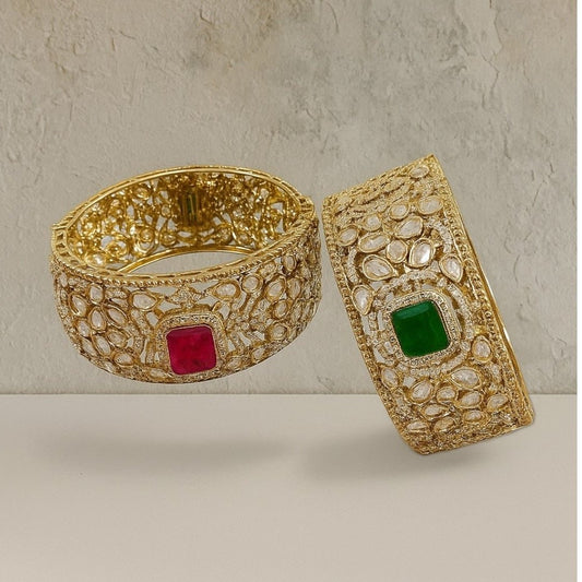 Gold - Plated Kundan Bangles with Pink & Green Square Stone - Auraa Trends - Bangles -  - Auraa Trends - Pair of gold - plated traditional kundan bangles with green and pink square center stones, displayed with floral decor on textured background.”