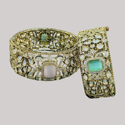 Gold - Plated Wide Kundan Bangles with Pastel Pink & Green Stones - Auraa Trends - Bangles -  - Auraa Trends - “Wide gold - plated kundan bangles with pastel pink and green center stones, traditional Indian bridal jewelry displayed on beige background.”