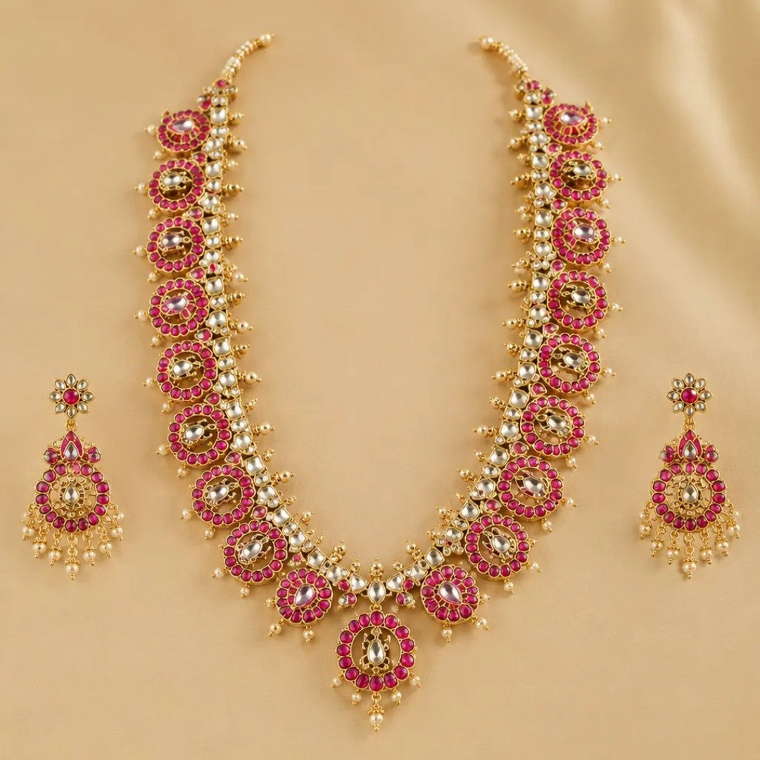 Gold-plated Kundan necklace set with pink ruby-look stones and matching statement earrings for bridal, wedding, festive, and traditional wear.
