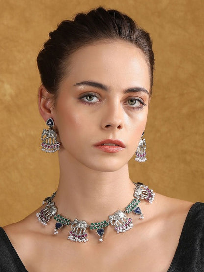 Oxidised silver-tone elephant motif necklace set with green, blue, and pink stones, pearl-style bead drops, and matching earrings