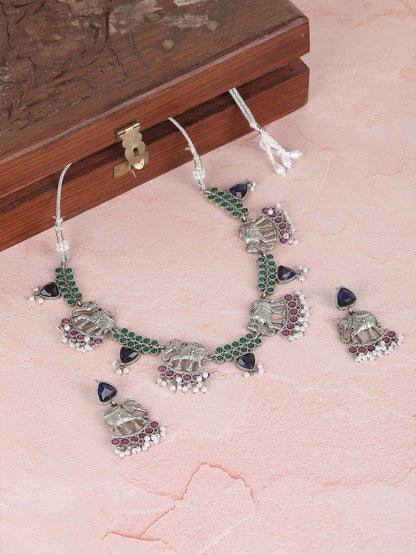 Oxidised silver-tone elephant motif necklace set with green, blue, and pink stones, pearl-style bead drops, and matching earrings