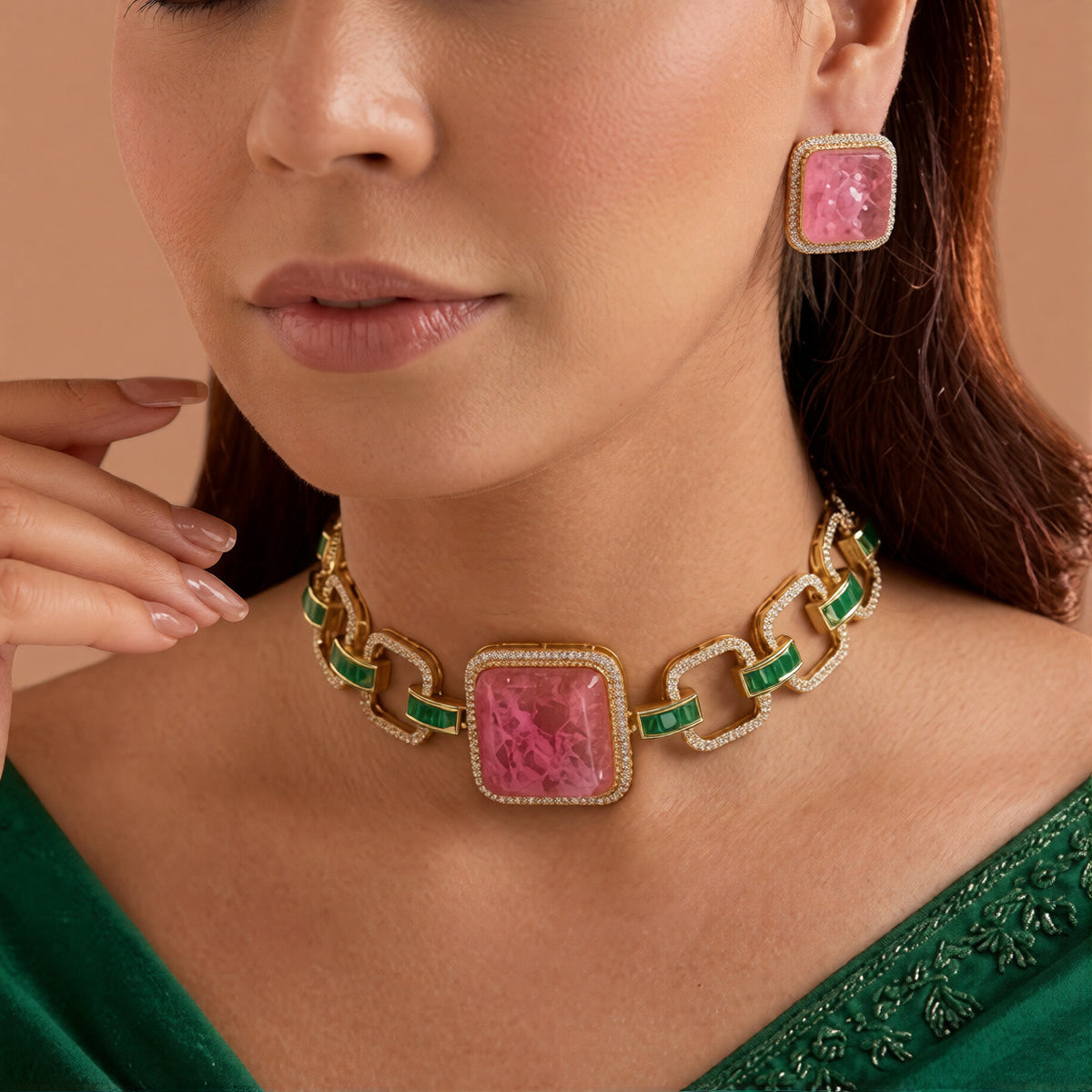 Gold plated choker necklace set with large square pink stone, green baguette stone links and matching pink stud earrings