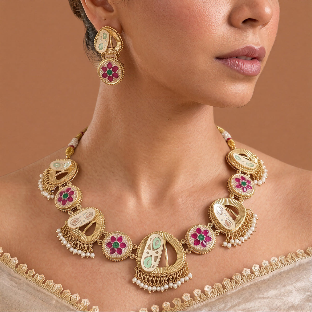 Antique gold heritage meenakari necklace set with mint green and peach enamel crescents, ruby-pink and emerald-green floral stone medallions, pearl fringe drops and matching earrings