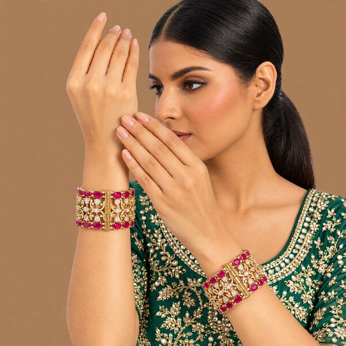 Pair of antique gold-finish wide kada bangles with ruby-pink rectangular stones, polki-style clear stones, and Victorian-style American diamond scrollwork