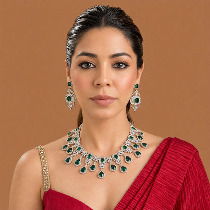Silver finish American diamond choker necklace set with emerald green stones, pear drops, zircon flower motifs and matching scrollwork drop earrings – Auraa Trends