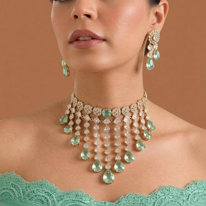 Gold kundan polki choker necklace set with mint green pear drops and matching floral earrings by Auraa Trends