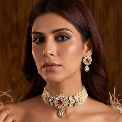Gold-plated kundan pearl choker necklace set with five white pearl strands, ruby-pink floral centre medallion, teardrop pendant and matching stud earrings