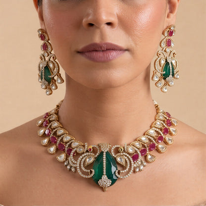 Gold-finish carved emerald peacock polki necklace set with ruby pink oval stones, zircon pavé scrollwork and matching long drop earrings
