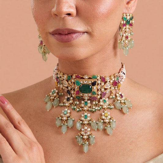 Gold-finish multicolour kundan polki jadau choker necklace set with emerald centre stone, seed pearl strands, lotus drops and matching stud earrings