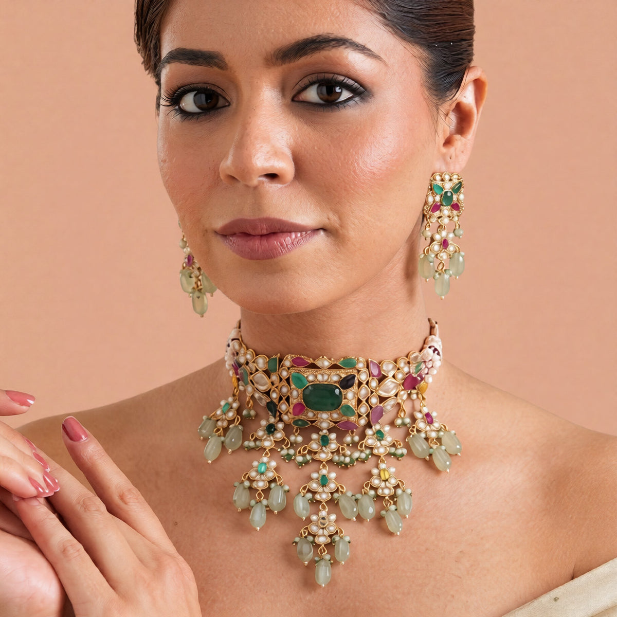 Gold-finish multicolour kundan polki jadau choker necklace set with emerald centre stone, seed pearl strands, lotus drops and matching stud earrings