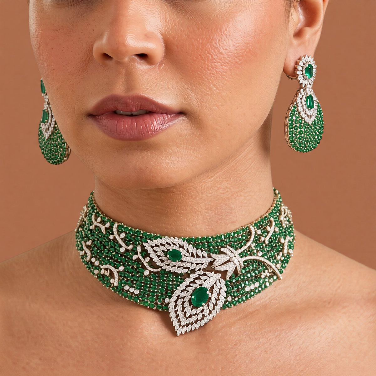 Emerald green American diamond wide choker necklace set with white zircon leaf motif and matching teardrop pavé earrings