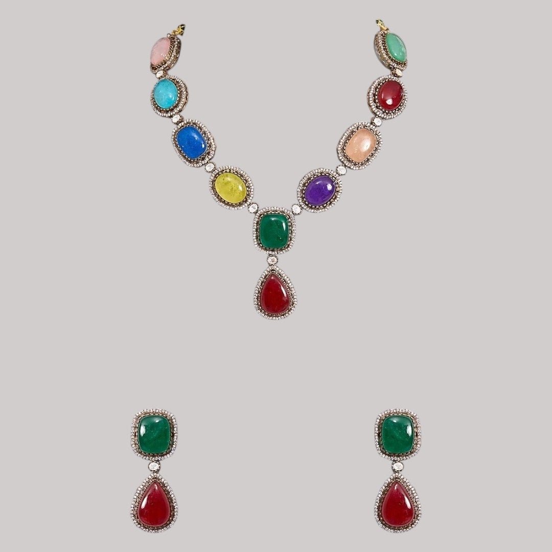 Luxury Multicolor Stone Statement Necklace Set with Earrings for Women - Auraa Trends - Necklace Set -  - Auraa Trends - Woman wearing a luxury multicolor gemstone statement necklace set with bold matching earrings, styled with a traditional embroidered saree blouse.