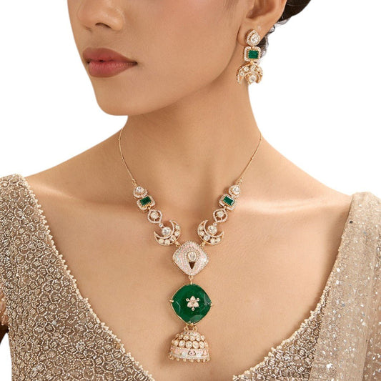 Regal Temple - Inspired Long Pendant Necklace Set with Green Accents and Bell Charm – Bridal Jewelry Set - Auraa Trends - necklace -  - Auraa Trends - Gold - toned temple - style necklace adorned with emerald green center piece, crescent motifs, and jhumka - style pendant, matched with corresponding earrings – perfect for brides and celebrations.