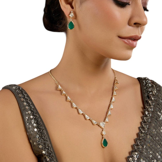 Sophisticated Kundan Necklace Set with Emerald Green Drop Pair of Matching Earrings - Auraa Trends - Necklace -  - Auraa Trends - Lady adorned with a gold colored kundan necklace featuring triangular patterns and a green teardrop pendant, complemented by matching green drop earrings.