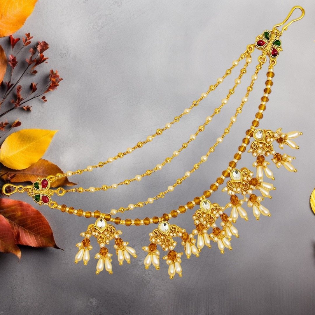 Traditional Kundan & Pearl Multi - Layer Kaan Chain - Auraa Trends - Kaan chain -  - Auraa Trends - Elegant multi - layered Kundan and pearl golden Kaan Chain (Ear Chain) with floral motifs and dangling pearl drops, displayed with decorative flowers and seashell.