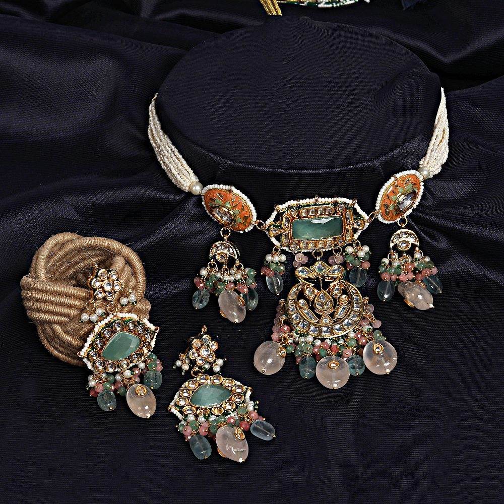Gold-tone kundan choker necklace with mint green stone, peach meenakari discs and pastel bead drops, shown with matching chandelier earrings