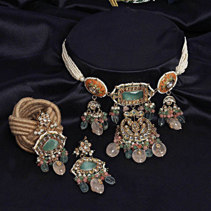 Gold-tone kundan choker necklace with mint green stone, peach meenakari discs and pastel bead drops, shown with matching chandelier earrings